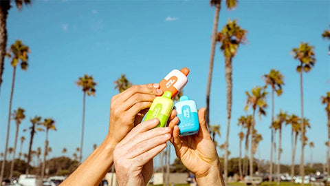 A Group Of Hands Holding Fifty Bar Vapes.